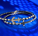 BRACCIALE RIGIDO IN ORO BIANCO CON CROCE CENTRALE DI DIAMANTI E DIAMANTI NERI