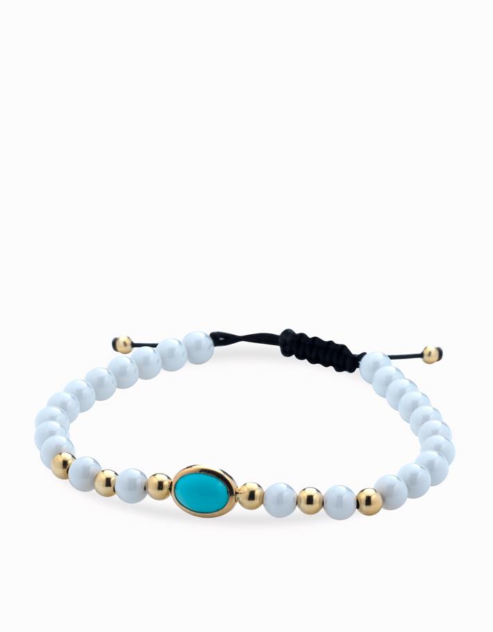 Bracciale con palline bianche in ceramica e oro giallo e pietra centrale azzurra Dalù Gioielli