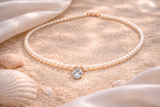 COLLANA IN ORO 9KT, ORO ROSA CON DIAMANTINI E CUORE ACQUAMARINA
