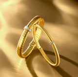 BRACCIALE IN ORO GIALLO 18KT, CON TITANIO E DIAMANTI CENTRALI