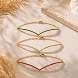 BRACCIALE A V IN ORO GIALLO CON RUBINI