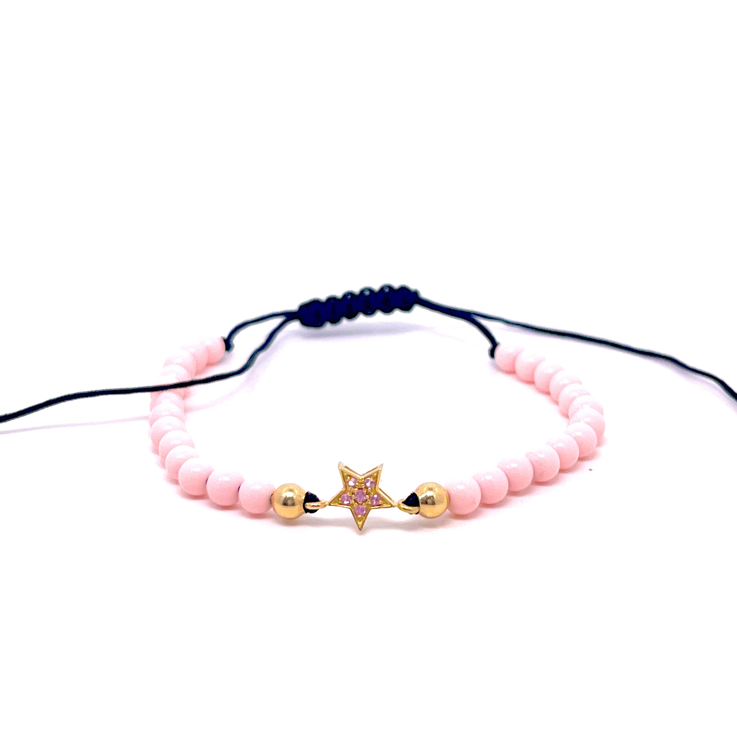 BRACCIALE CON STELLA CENTRALE E ZAFFIRI ROSA IN ORO GIALLO E PASTA DI CORALLO ROSA
