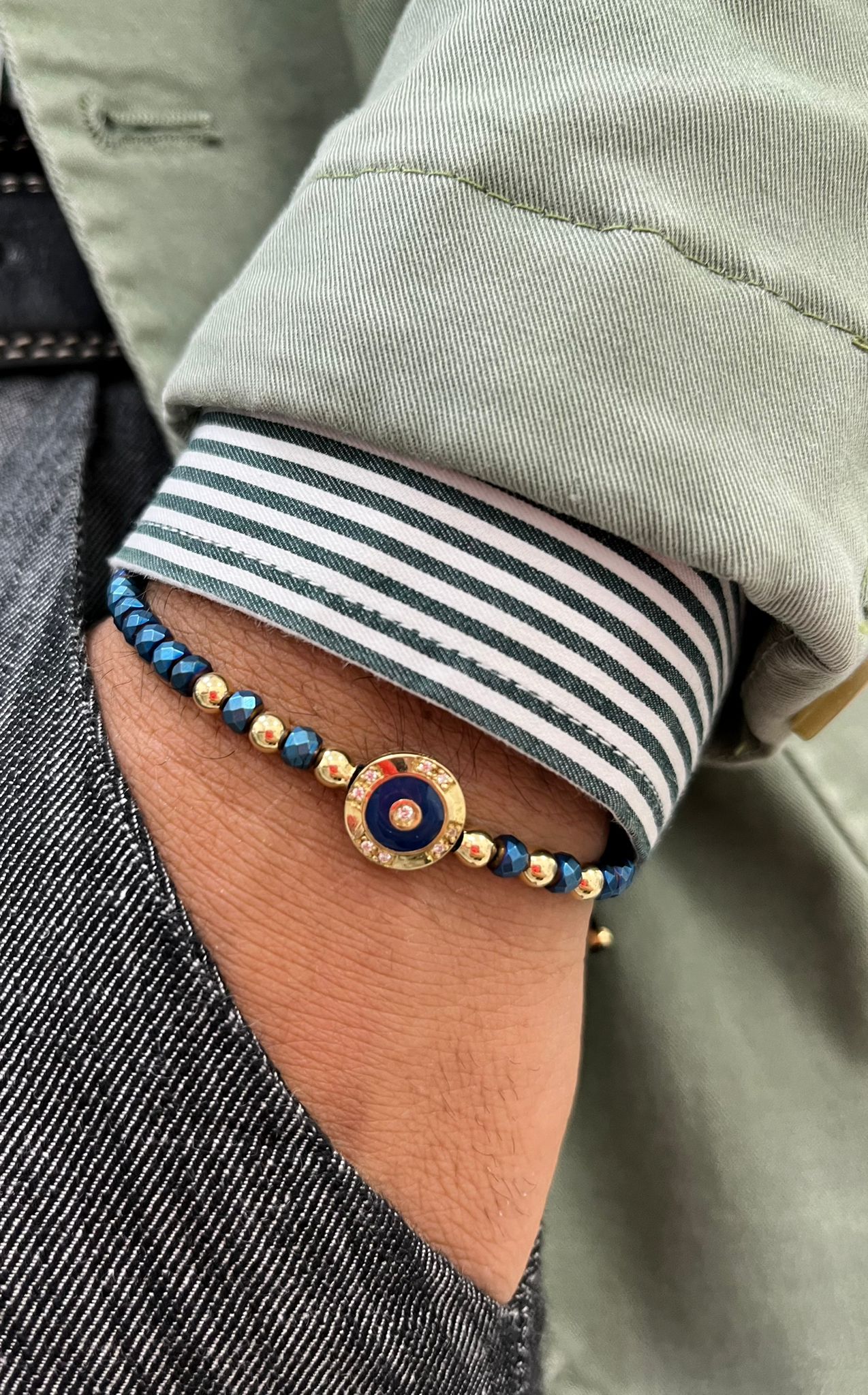 Bracciale monetina in oro giallo con diamantini ed ematite blu